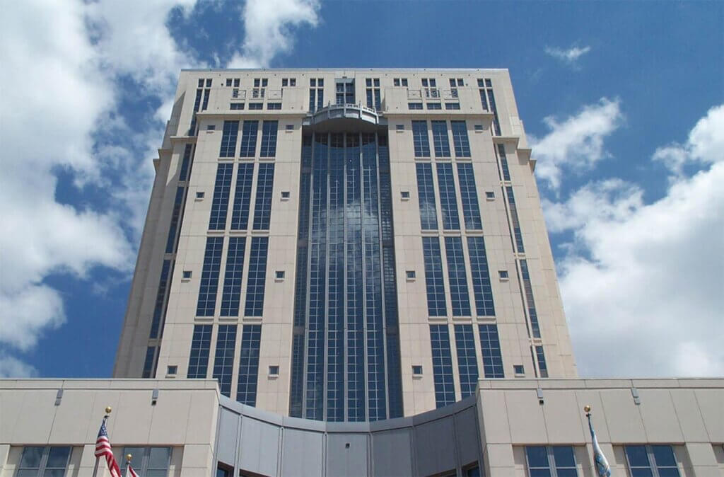 Image of the Ninth Circuit Courthouse building with blue sky and clouds behind it.